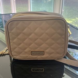 Itsy ritzy tan cross body diaper bag/purse. Six compartments +changing pad.